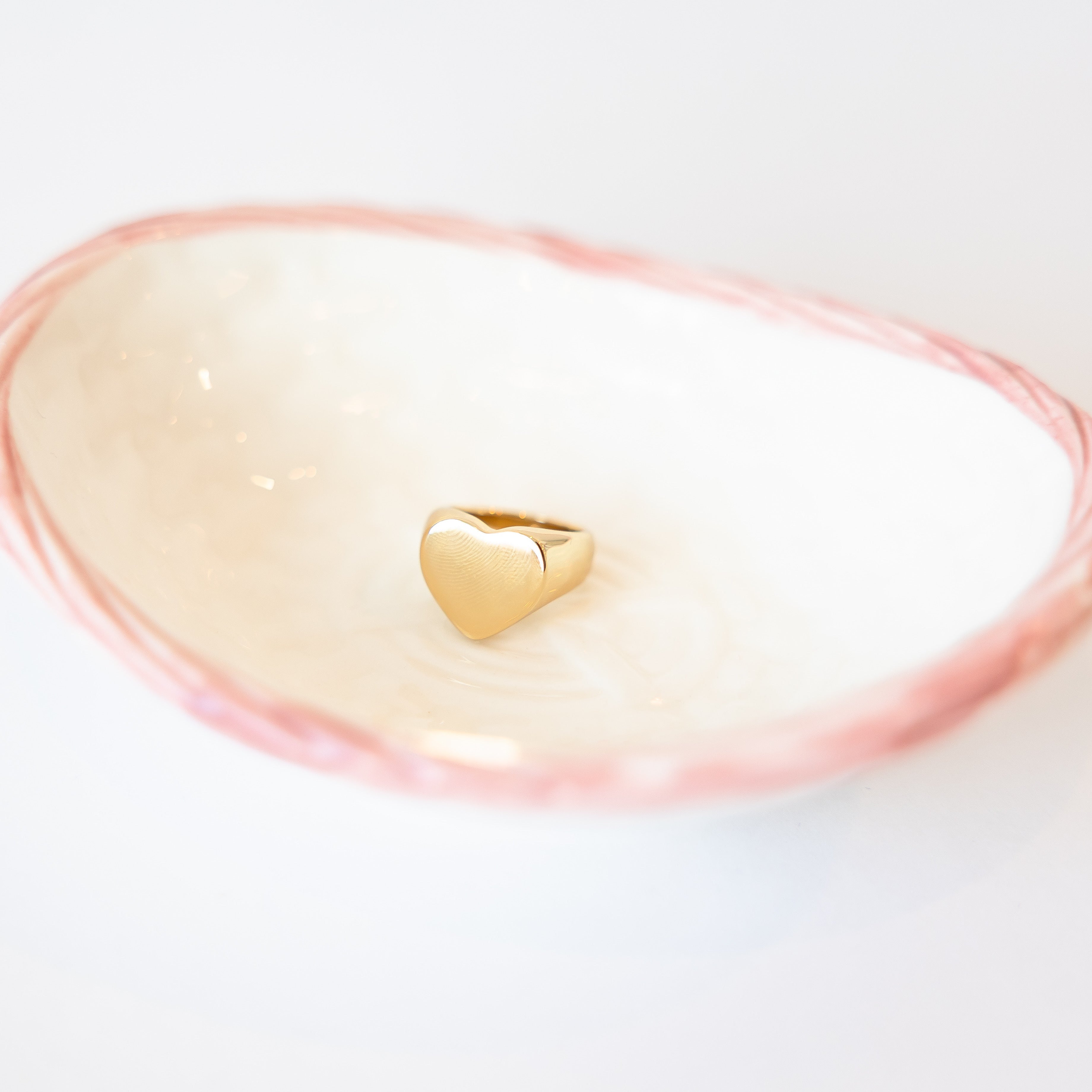 Gold heart-shaped object on a white background