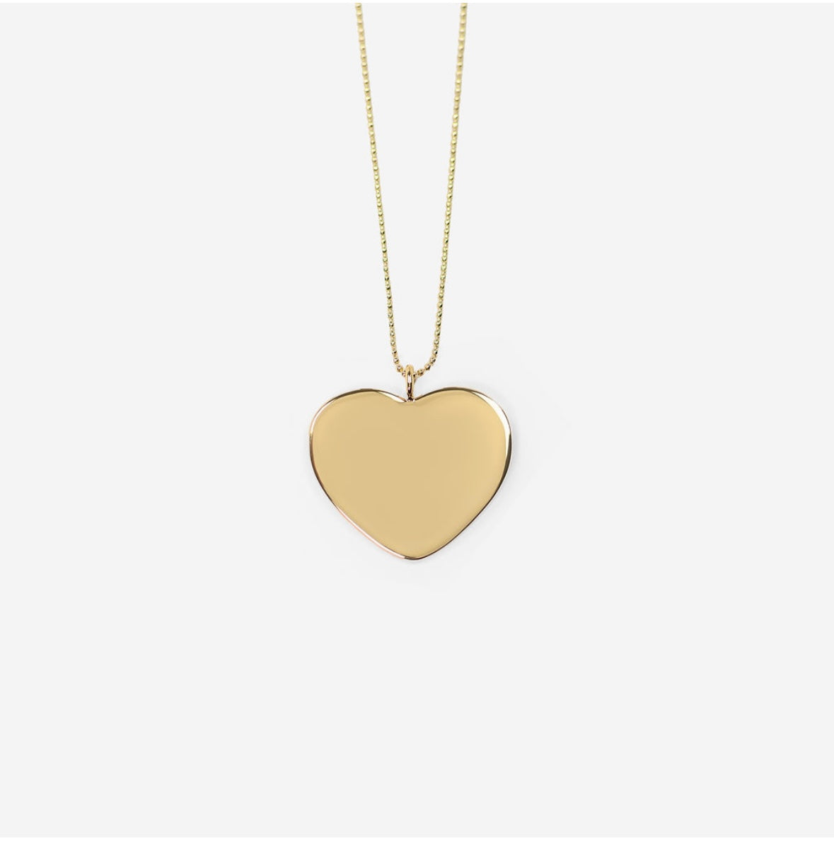 A gold-plated heart-shaped necklace on a beaded chain displayed against a white background.