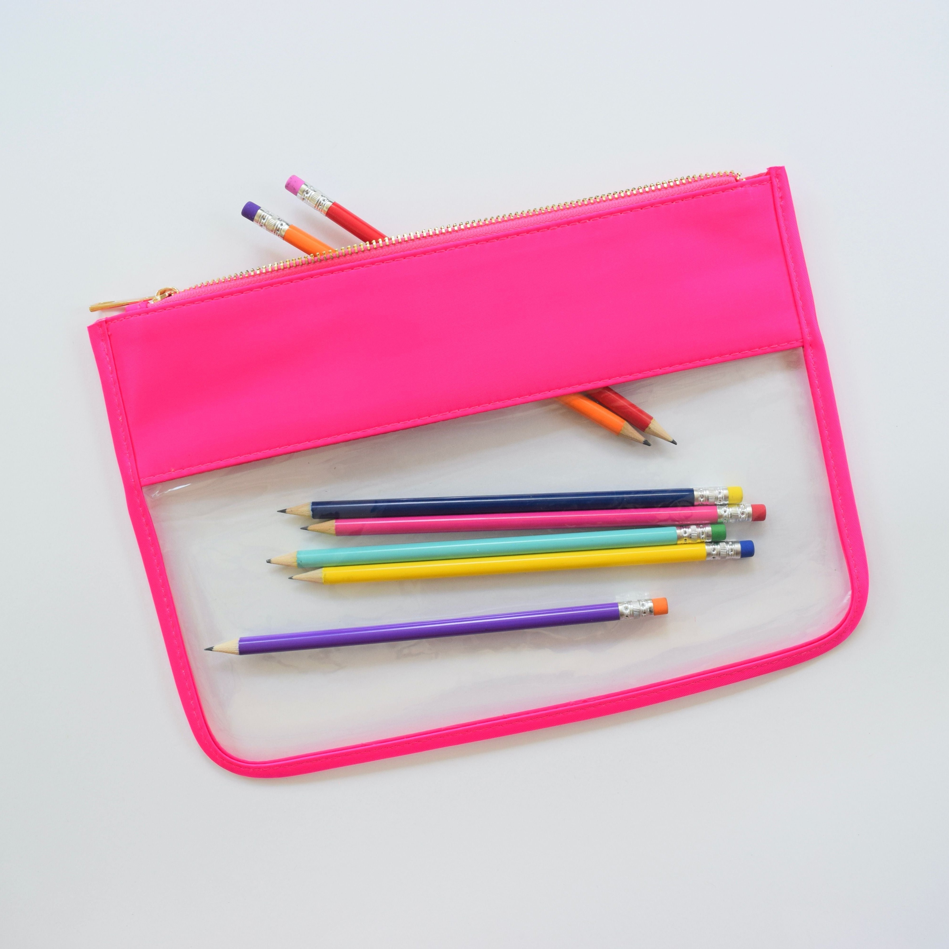 A pink and white cosmetic and toiletry bag with a zipper closure.