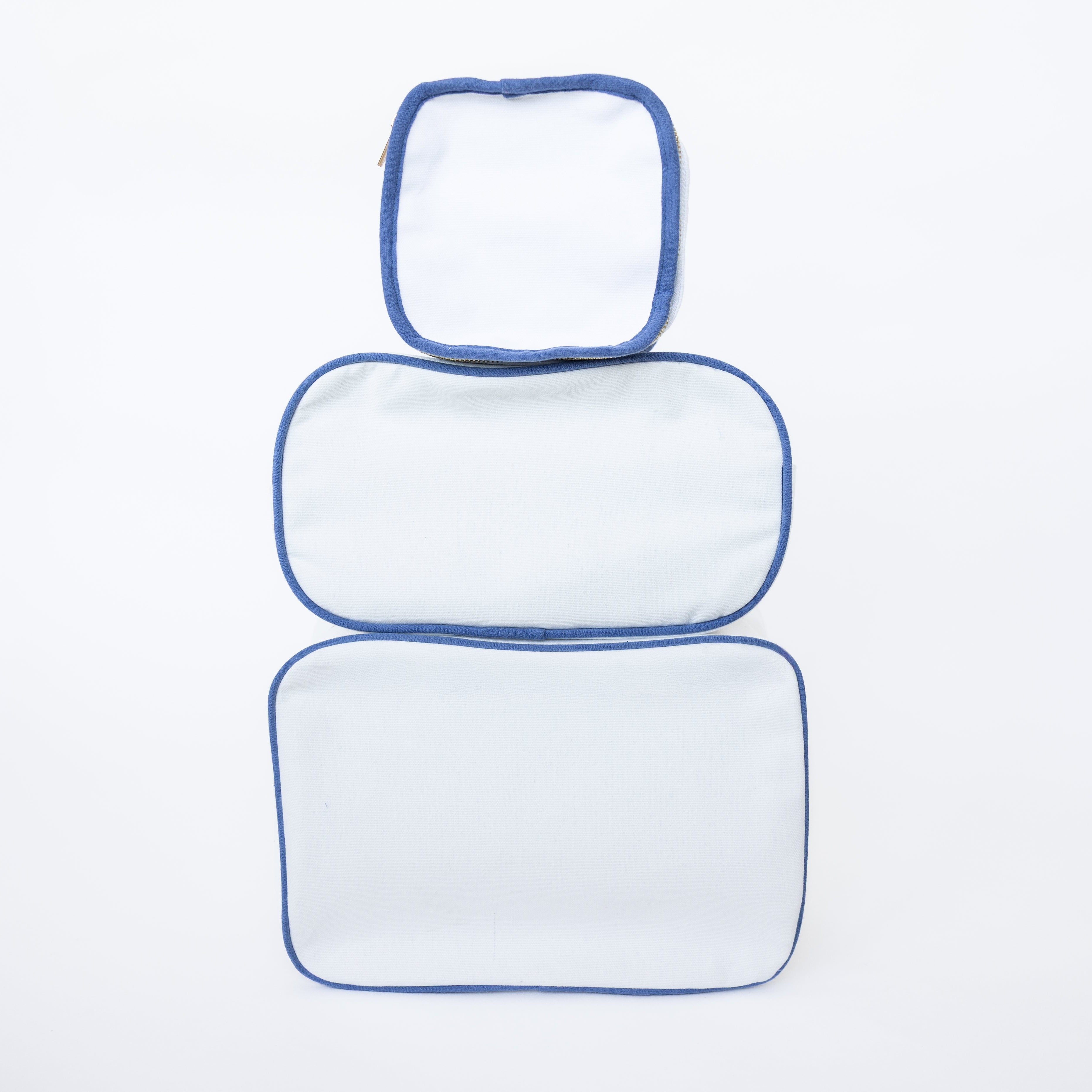 Three rectangular cushions with blue outlines on a white background